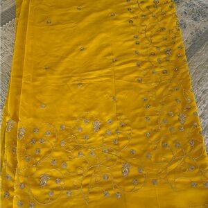 Yellow georgette saree with silver sparkly embroidery